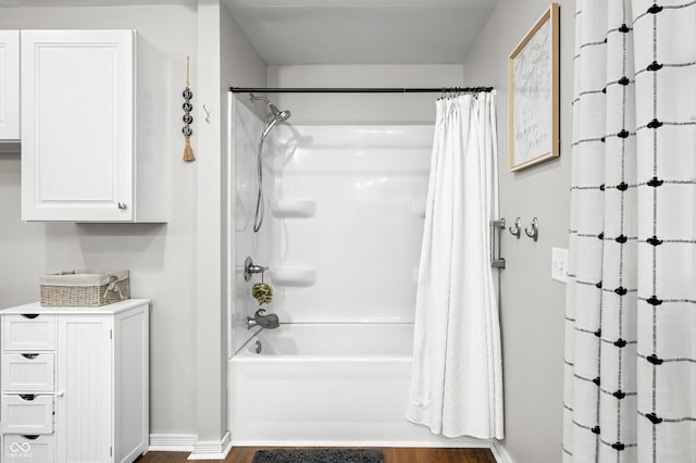 bathroom featuring shower / tub combo and hardwood / wood-style floors