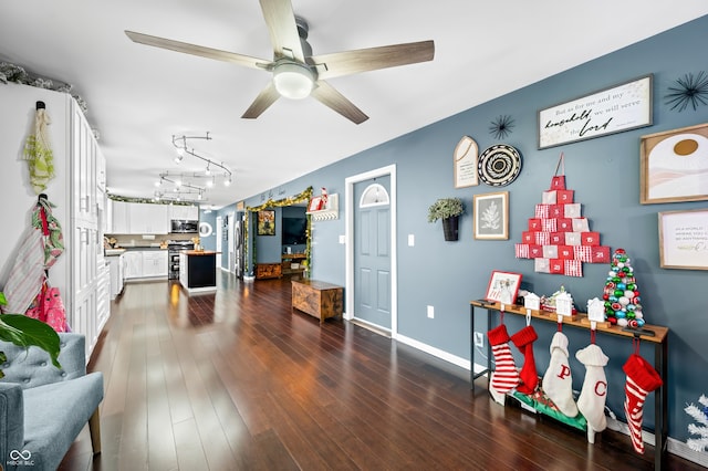 miscellaneous room featuring ceiling fan and dark hardwood / wood-style floors