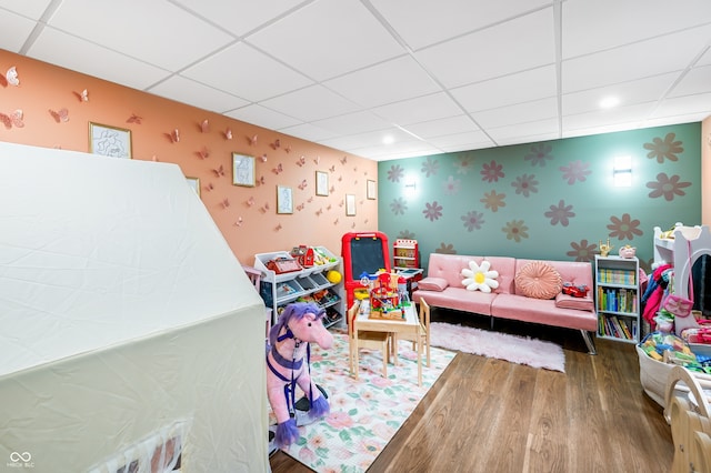 rec room with a paneled ceiling and hardwood / wood-style flooring