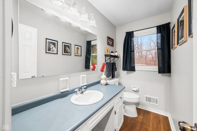 bathroom featuring hardwood / wood-style floors, vanity, and toilet