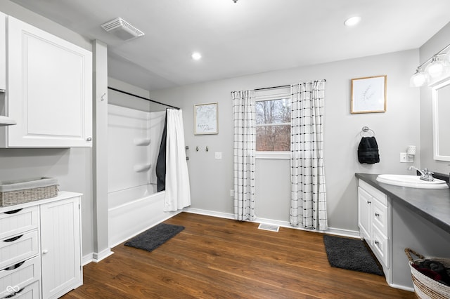 bathroom with shower / bathtub combination with curtain, vanity, and wood-type flooring