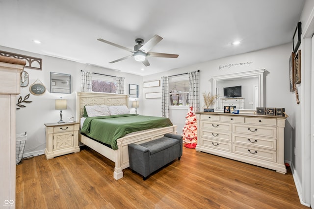 bedroom with ceiling fan and wood-type flooring