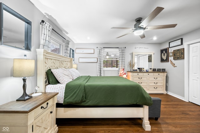 bedroom with dark hardwood / wood-style flooring and ceiling fan