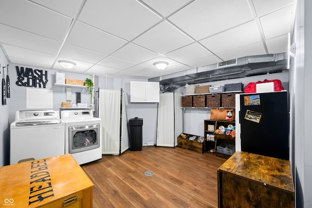 laundry area with wood-type flooring and independent washer and dryer