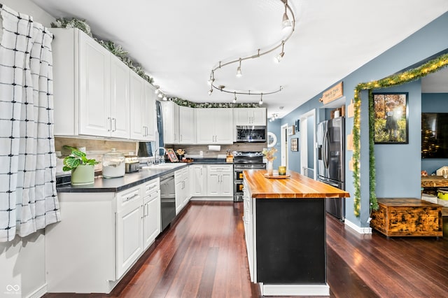 kitchen with tasteful backsplash, white cabinetry, and stainless steel appliances