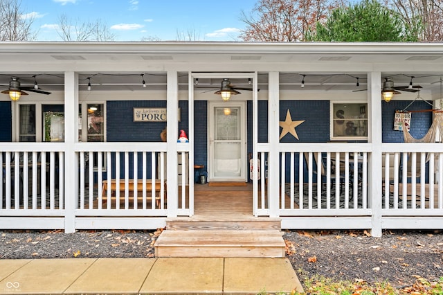 entrance to property featuring ceiling fan and a porch