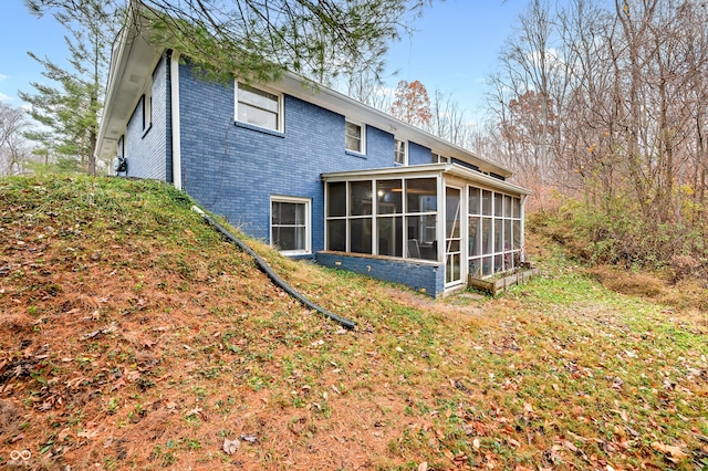 back of house featuring a sunroom