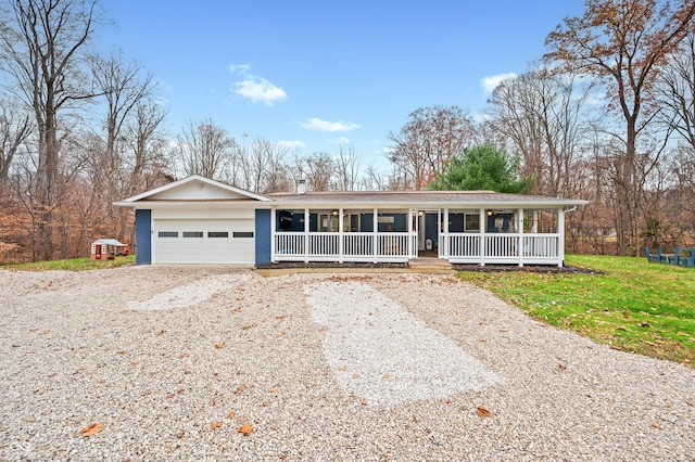 ranch-style home featuring covered porch and a garage