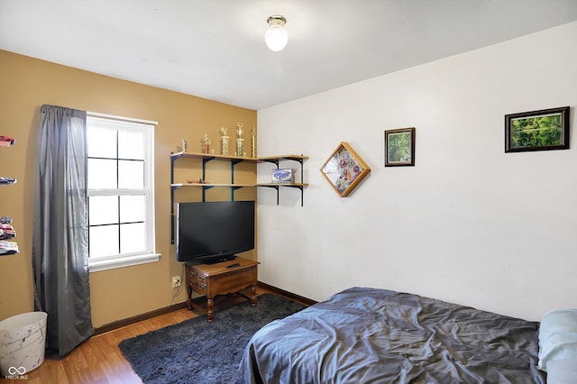 bedroom with dark hardwood / wood-style flooring