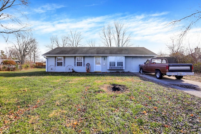 ranch-style house featuring a garage and a front yard