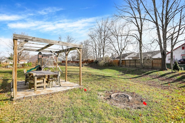 view of yard with a playground and an outdoor fire pit