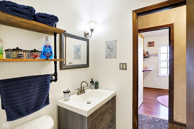 bathroom featuring hardwood / wood-style floors, vanity, and toilet