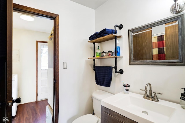 bathroom featuring vanity, toilet, and wood-type flooring