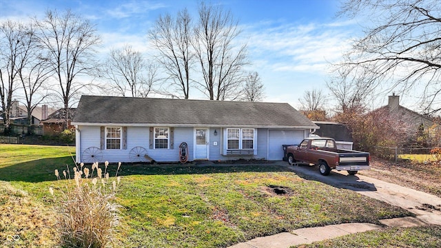 ranch-style home featuring a garage and a front lawn