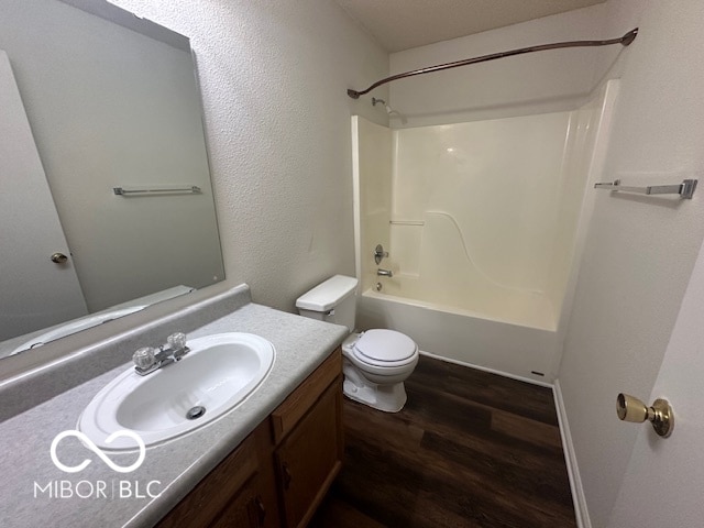 full bathroom featuring vanity, toilet, wood-type flooring, and bathing tub / shower combination