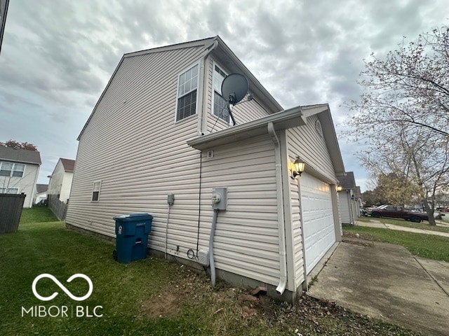 view of property exterior with a yard and a garage