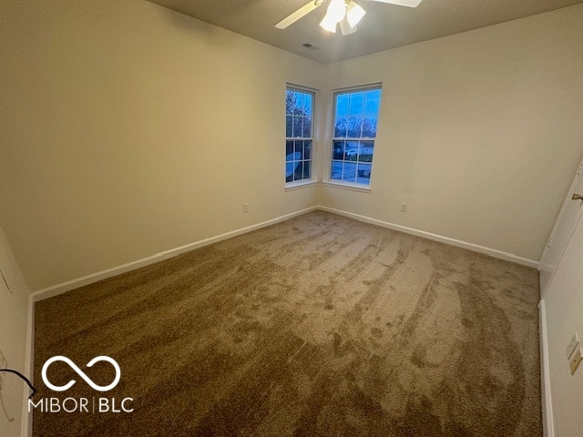 spare room with carpet flooring and ceiling fan