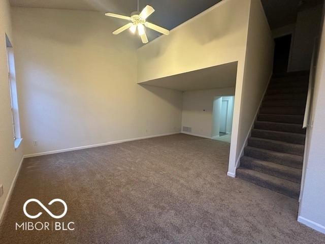 interior space with carpet floors, high vaulted ceiling, and ceiling fan