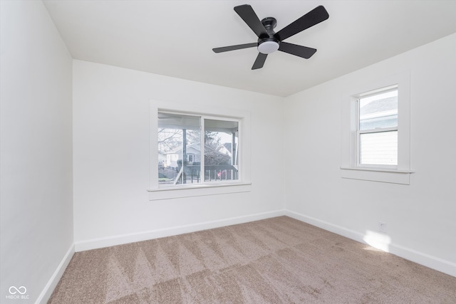 spare room featuring ceiling fan, a healthy amount of sunlight, and carpet floors