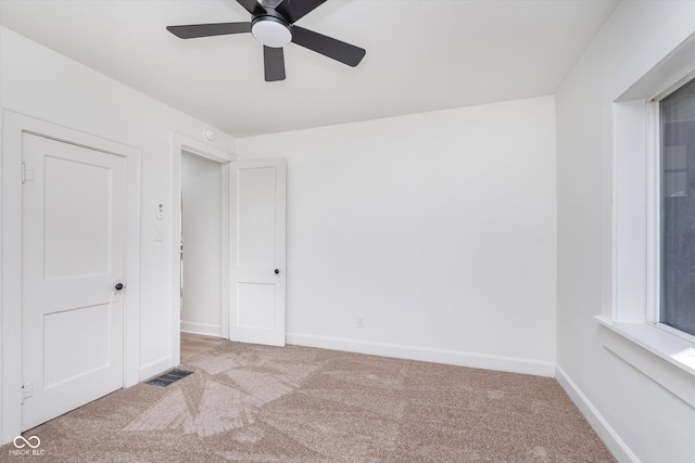 unfurnished bedroom featuring ceiling fan and light carpet