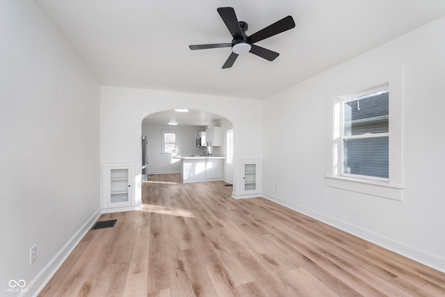 unfurnished living room with ceiling fan and light wood-type flooring