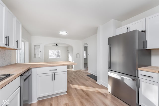 kitchen with butcher block countertops, ceiling fan, white cabinets, and appliances with stainless steel finishes