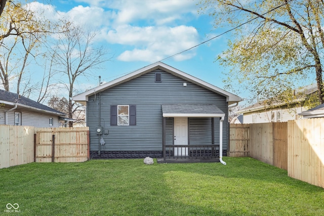 rear view of property with a yard