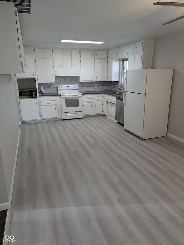 kitchen with white cabinetry, backsplash, appliances with stainless steel finishes, and light hardwood / wood-style flooring