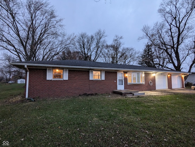 single story home featuring a garage and a front yard