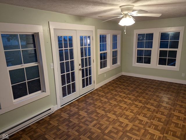 unfurnished sunroom with ceiling fan, french doors, and a baseboard radiator