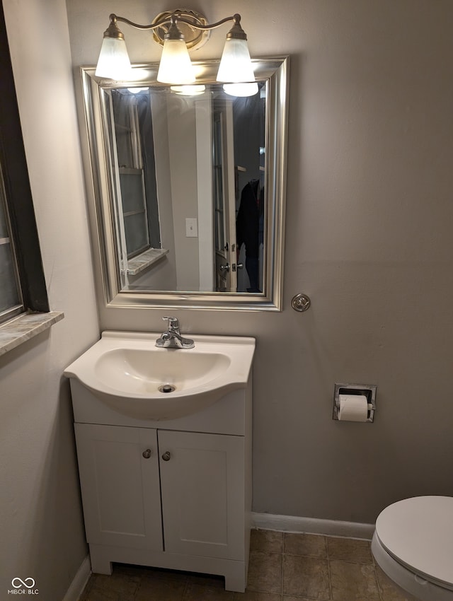 bathroom with tile patterned floors, vanity, and toilet