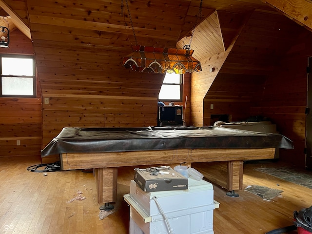 bedroom featuring hardwood / wood-style flooring, wood walls, lofted ceiling, and wood ceiling