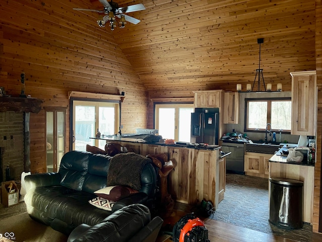 living room with ceiling fan, sink, dark hardwood / wood-style flooring, high vaulted ceiling, and wood walls