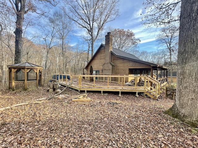 227 Victory Hl, Coatesville, IN 46121 - back of property featuring a gazebo, a chimney, a deck, and a metal roof