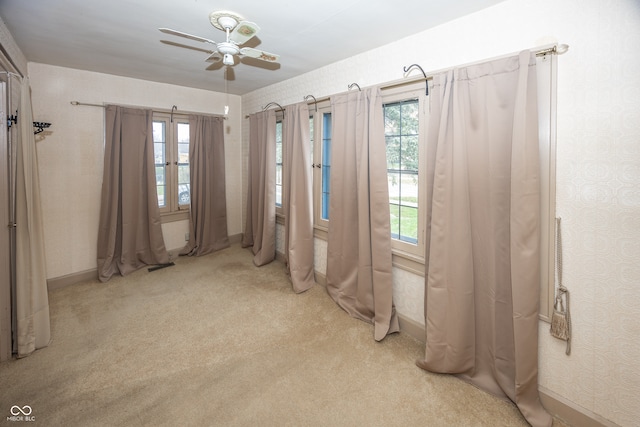 carpeted empty room with ceiling fan