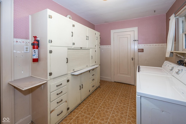 1330 N Bosart Ave, Indianapolis, IN 46201 - laundry room with independent washer and dryer, cabinet space, wallpapered walls, and wainscoting