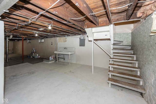 1330 N Bosart Ave, Indianapolis, IN 46201 - unfinished basement featuring stairs, electric panel, and a sink