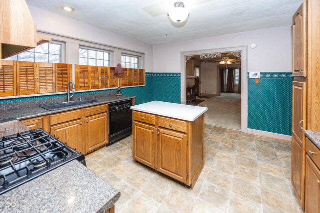 1330 N Bosart Ave, Indianapolis, IN 46201 - kitchen with black appliances, a sink, a ceiling fan, a wainscoted wall, and a center island