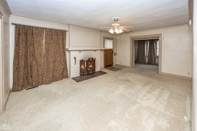 unfurnished living room with a textured ceiling, ceiling fan, and light carpet