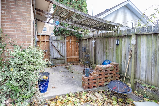 view of patio featuring a pergola and an outdoor fire pit