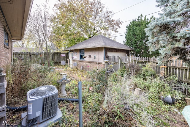 1330 N Bosart Ave, Indianapolis, IN 46201 - fenced backyard featuring cooling unit, a garage, and an outbuilding