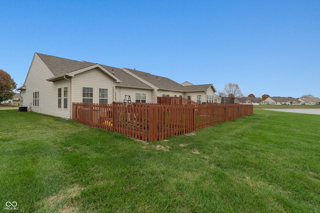 rear view of property with a yard