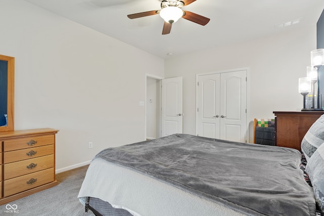 bedroom featuring ceiling fan, light carpet, and a closet