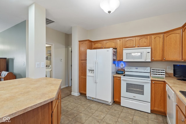 kitchen with washer and dryer and white appliances