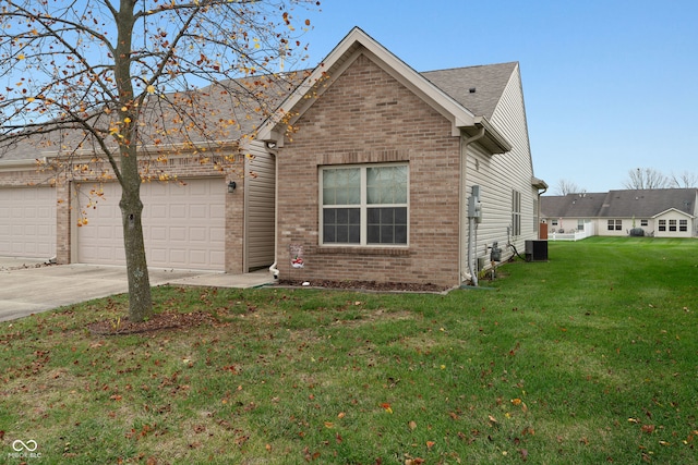 view of front of home with a front yard, a garage, and cooling unit