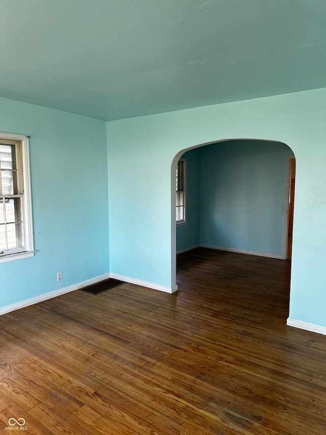 unfurnished room featuring dark hardwood / wood-style floors