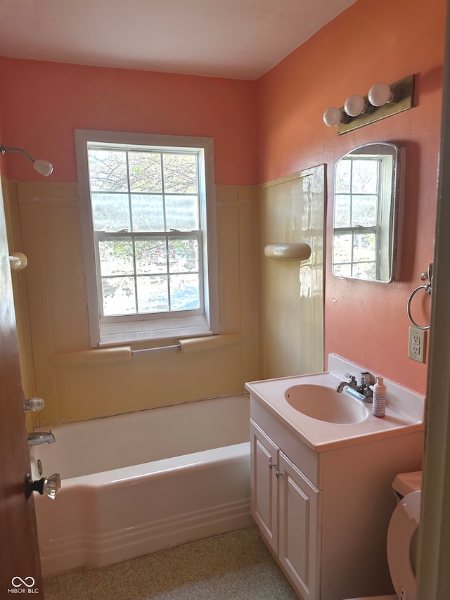 full bathroom featuring washtub / shower combination, vanity, and toilet