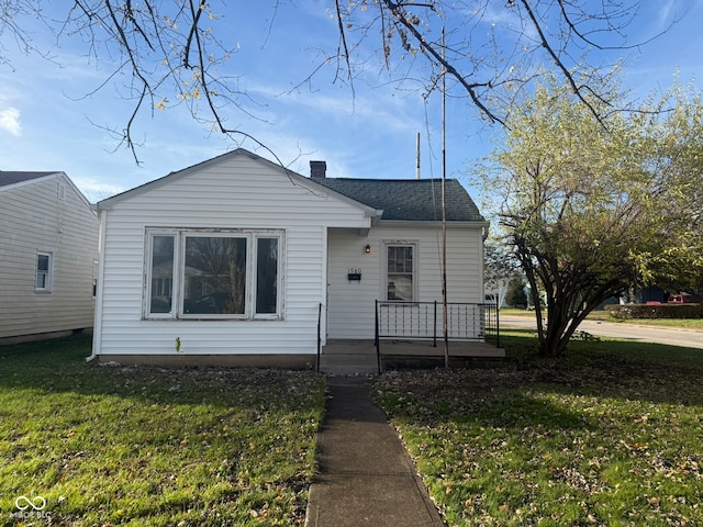 bungalow-style house with a front yard