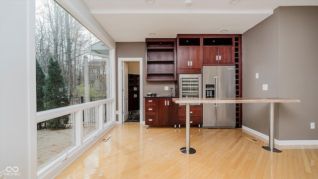 kitchen with light hardwood / wood-style floors, sink, a wealth of natural light, and high end refrigerator