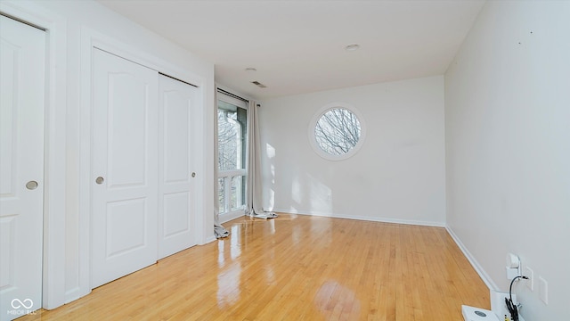 unfurnished bedroom featuring hardwood / wood-style flooring